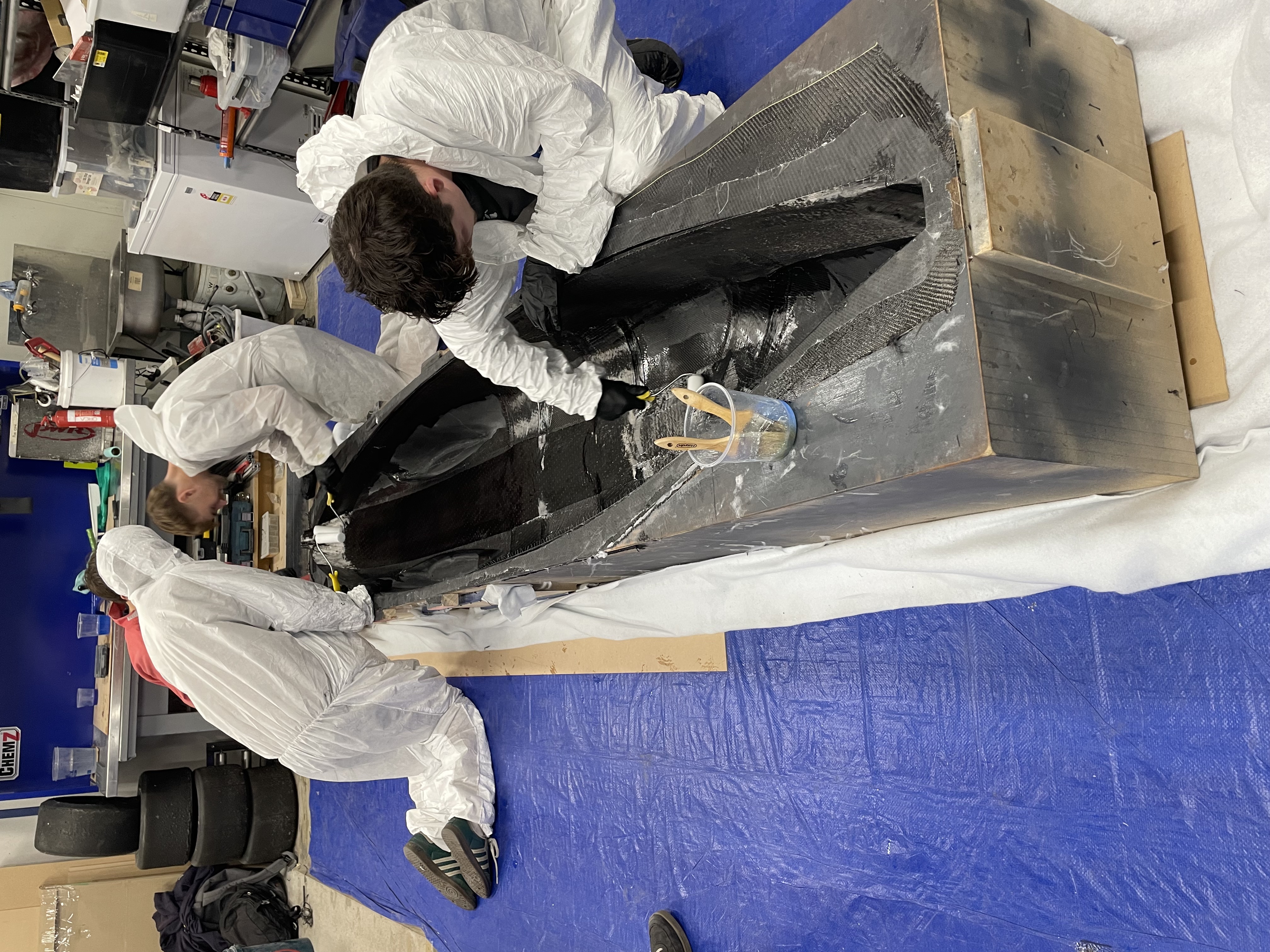 Laying the unidirectional carbon fiber down the lenth of the bikes monocoque.